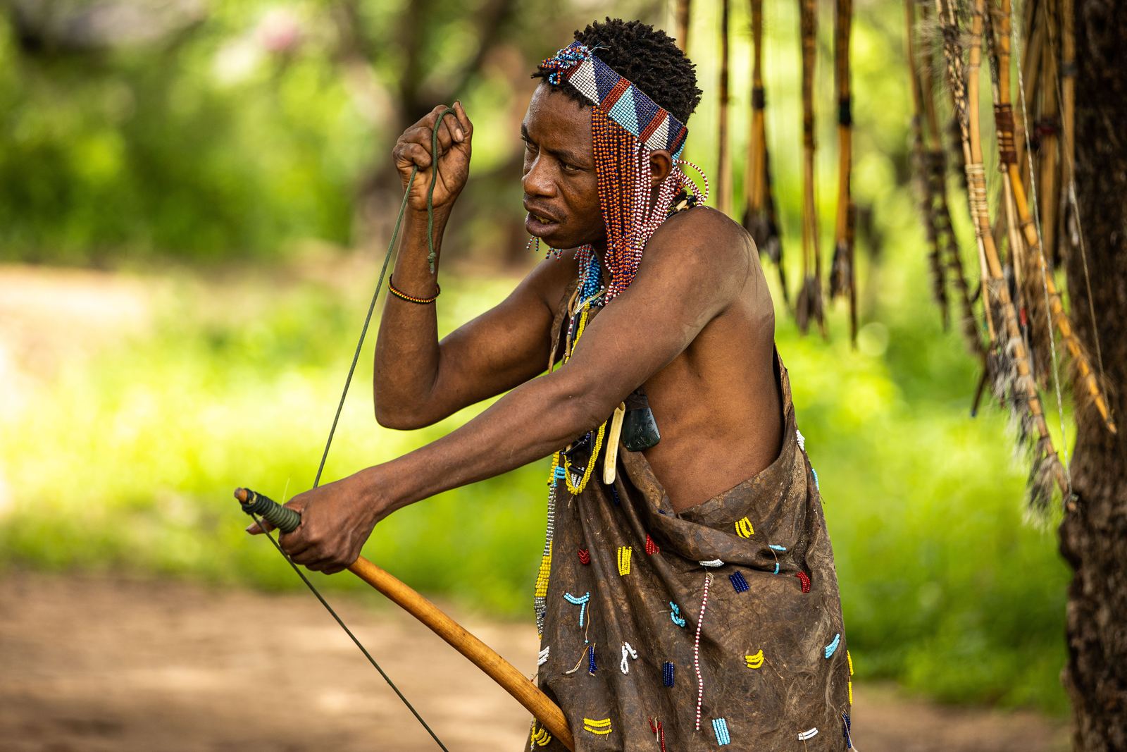 A Hadzabe man stringing his bow near Lake Eyasi